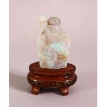 A CHINESE OPALITE CARVED SNUFF BOTTLE & STAND, carved depicting a fish, 4.5cm