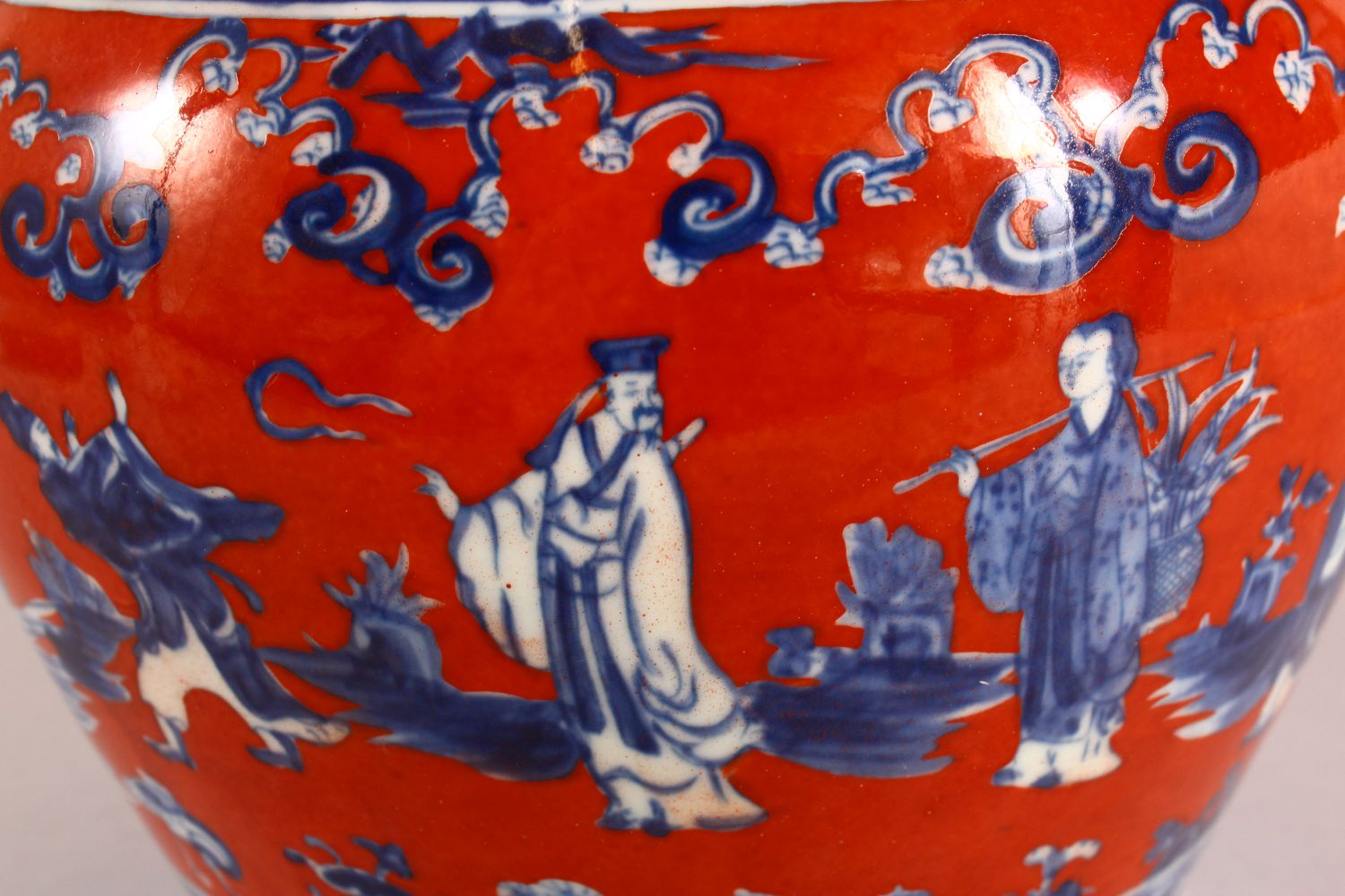 A CHINESE CORAL RED GROUND UNDERGLAZE BLUE PORCELAIN GINGER JAR & COVER, decorated with immortals in - Image 5 of 10