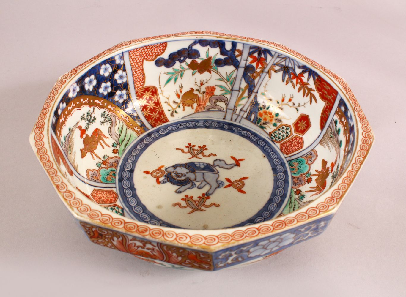 A JAPANESE MEIJI PERIOD IMARI DECAGON SHAPED PORCELAIN BOWL, with underglaze blue Shi shi dog,