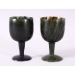 A GOOD PAIR OF MUGHAL CARVED SPINACH GREEN JADE GOBLETS, 10cm high X 5.6cm diameter.