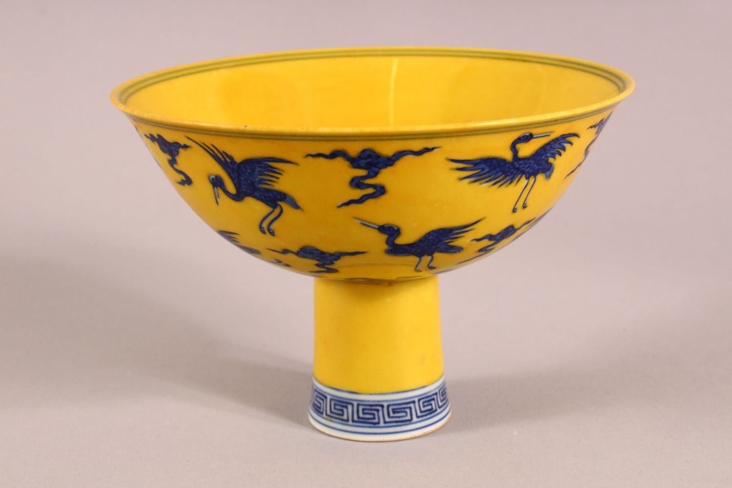 A CHINESE YELLOW GROUND PORCELAIN STEM CUP, decorated with cranes in flight, the interior of the - Image 3 of 6