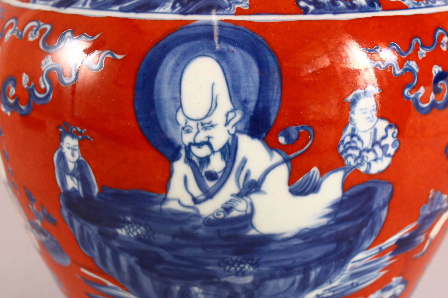 A CHINESE CORAL RED GROUND UNDERGLAZE BLUE PORCELAIN GINGER JAR & COVER, decorated with immortals in - Image 6 of 10