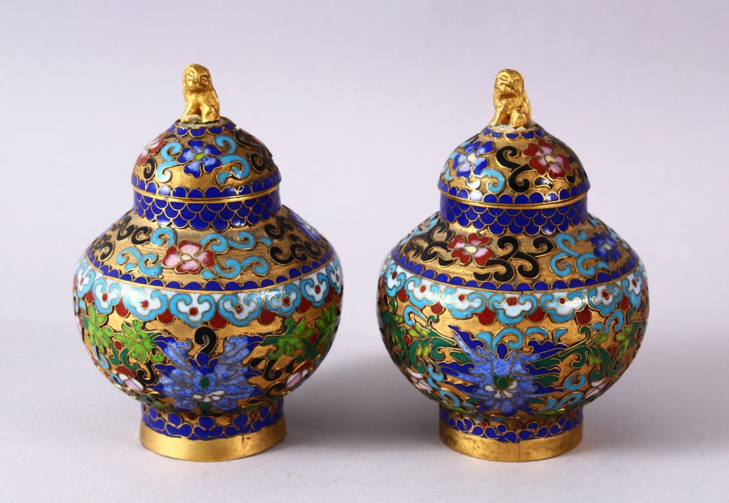 A PAIR CHINESE CLOISONNE JAR & COVERS, each decorated in similar style with raised enamel decoration