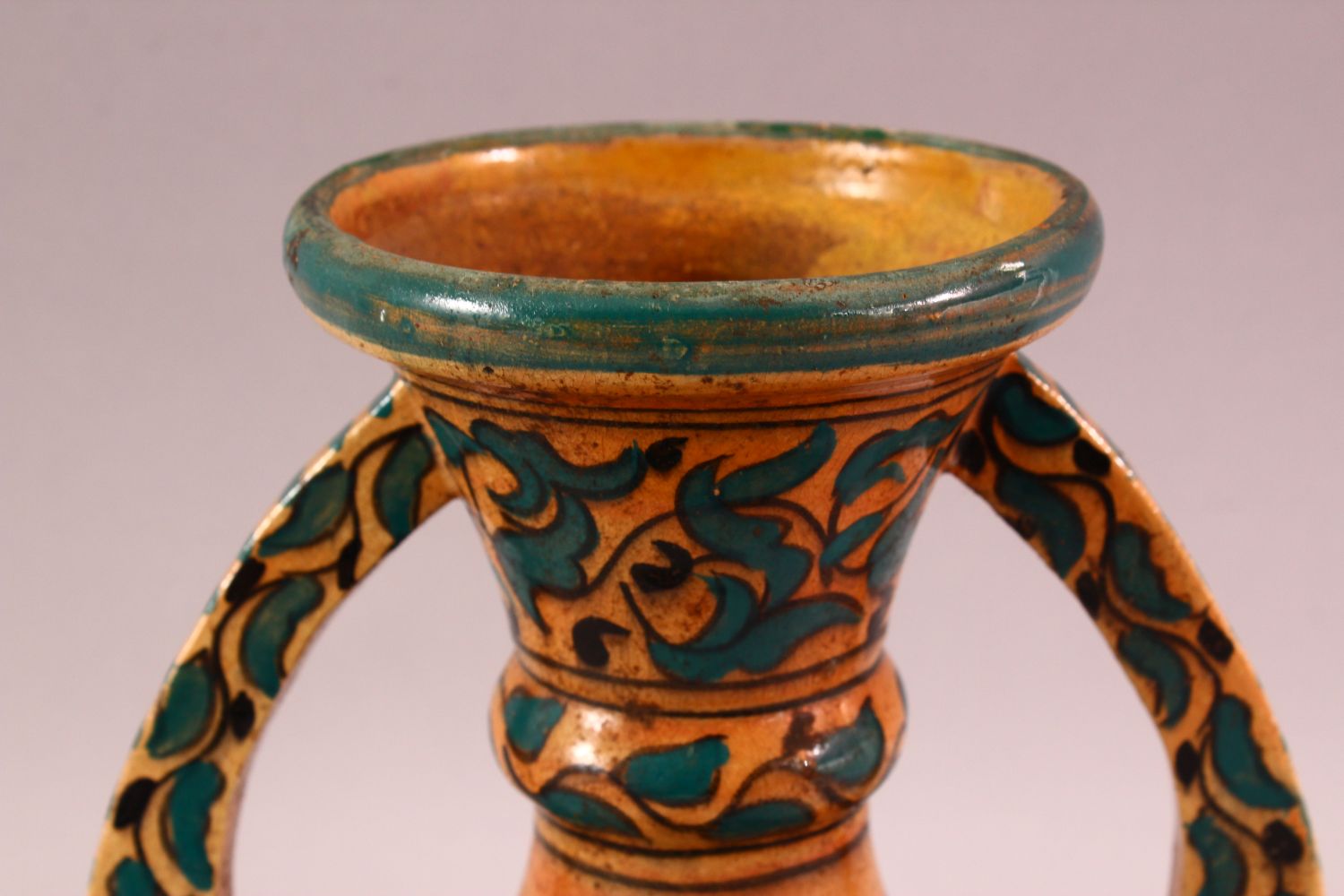 A MOROCCAN POTTERY FLORAL VASE - SIGNED BY BIN JALAL, with twin handles and green foliage - Image 2 of 8