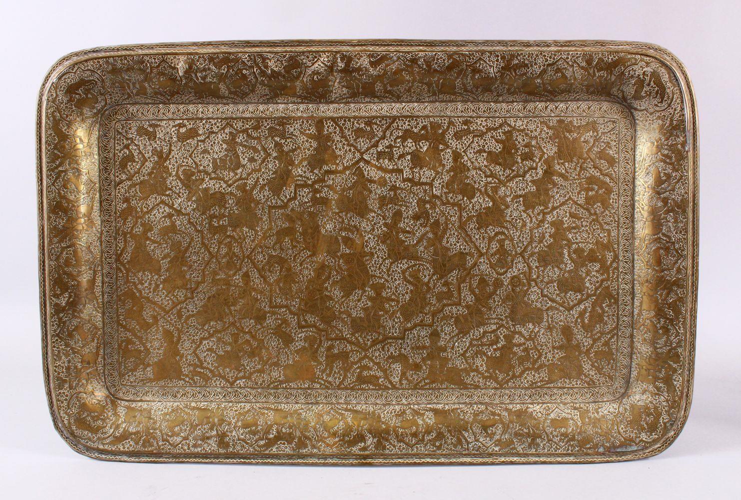 A GOOD PERSIAN QAJAR ENGRAVED HUNTING SCENE BRASS TRAY, carved with various hunting scenes, around