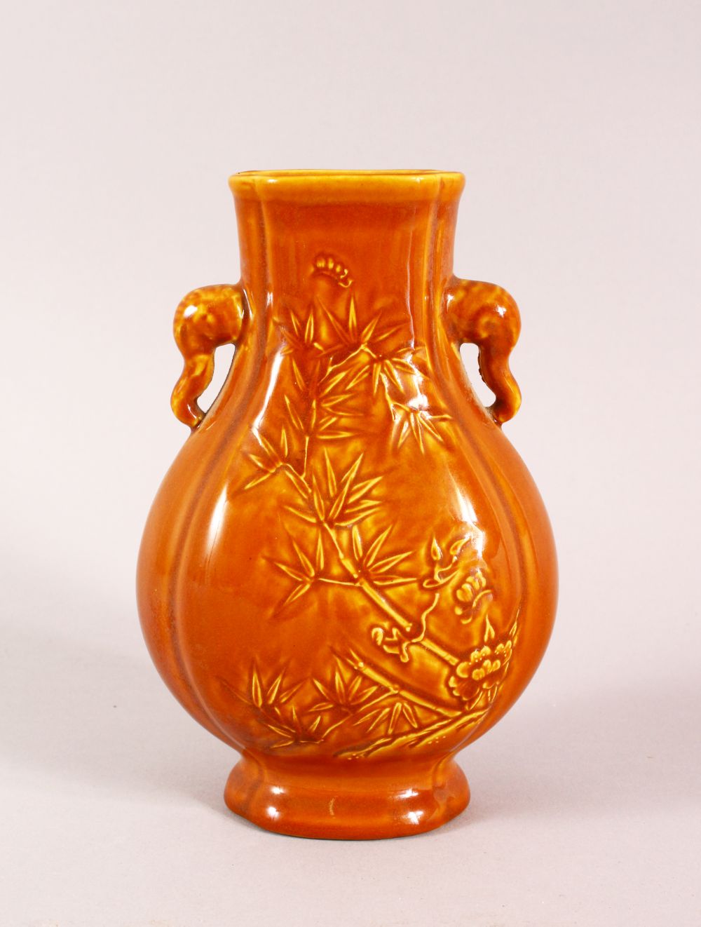 A CHINESE YELLOW GLAZED BAMBOO TWIN HANDLE VASE, the base with a seal mark, 16cm high