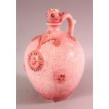 A EUROPEAN PINK GLAZED POTTERY BOTTLE FOR THE ISLAMIC MARKET, with moulded floral decoration and a