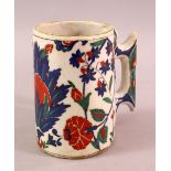 AN 18TH CENTURY TURKISH OTTOMAN IZNIK CUP / MUG, with a white ground and floral decoration, 13cm