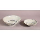 TWO CHINESE POSSIBLY MING BLUE & WHITE POTTERY BOWLS, one with central calligraphy, the other with
