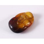 A CHINESE CARVED AMBER FIGURE OF SHOU LAO - carved in deep relief to depict shou lao holding a