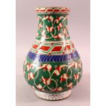 A TURKISH OTTOMAN 18TH CENTURY IZNIK VASE, with green and red motif decorations, 26cm
