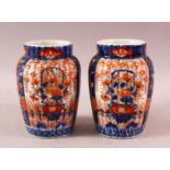 A PAIR OF JAPANESE MEIJI PERIOD PORCELAIN IMARI VASES, with ribbed body and floral panel decoration,