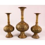 THREE PERSIAN ISLAMIC CALLIGRAPHIC BRASS VASES, each with calligraphy and motif decoration, 43cm ,