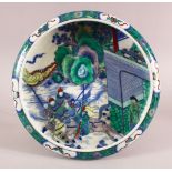 A CHINESE FAMILLE VERTE KANGXI STYLE PORCELAIN DISH, with figures on horseback in landscapes, the