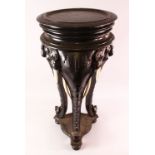 A LARGE INDIAN CARVED EBONISED WOOD AND IVORY ELEPHANT FORMED TRIPOD TABLE, the legs formed as