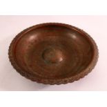 A GOOD PERSIAN ENGRAVED SIGNED BRASS MAGIC BOWL, the interior carved with a profuse amount of