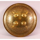 AN INDIAN ENGRAVED BRASS & SILVERED SHIELD, the shield with engraved floral motif decorations,