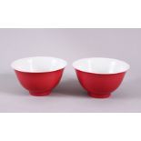 A PAIR OF 19TH / 20TH CENTURY CHINESE RUBY RED GLAZED PORCELAIN TEA BOWLS, with a ruby red / pink