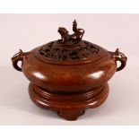 A CHINESE BRONZE TWIN HANDLED CENSER, the top with a pierced bat cover and dog final, with twin