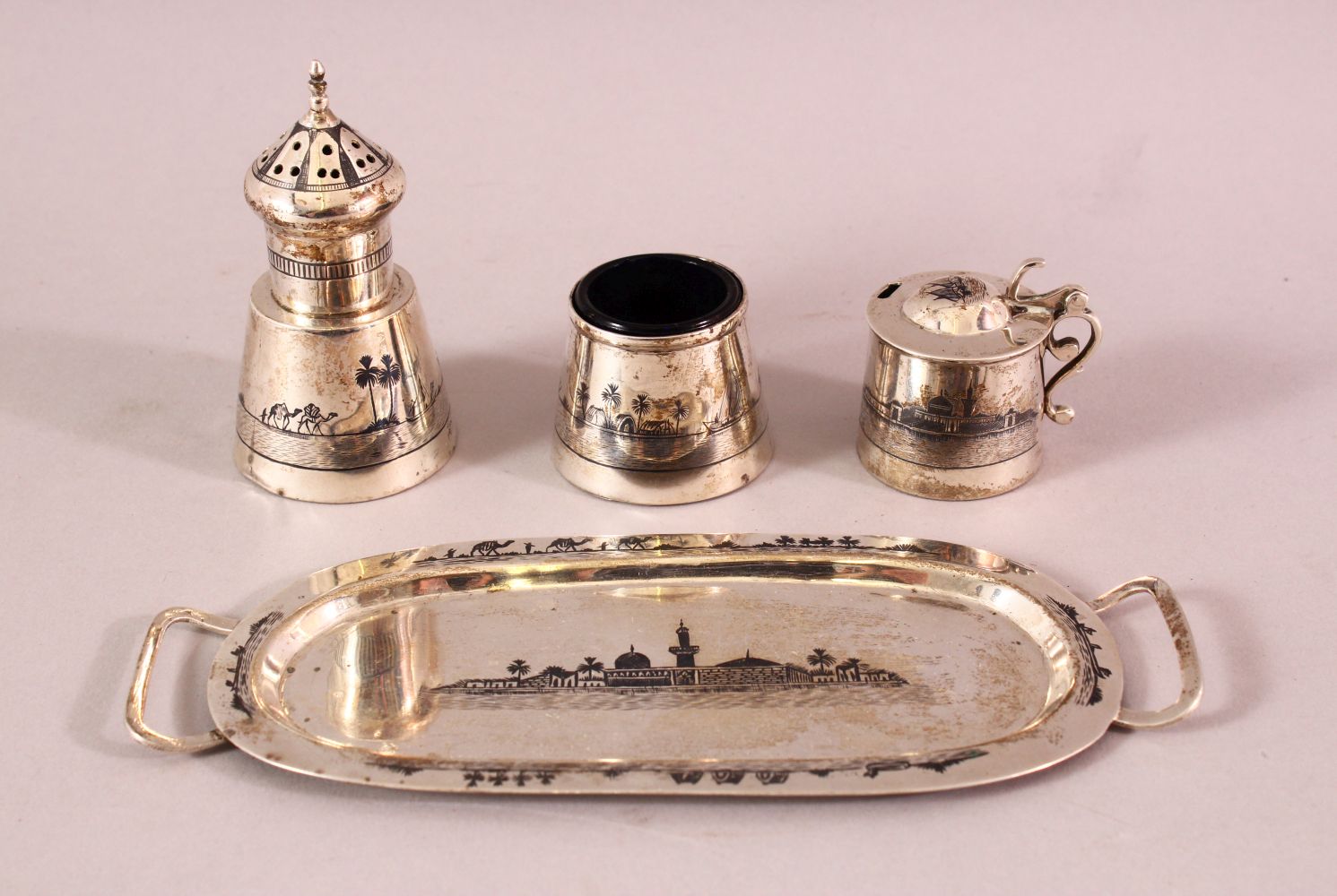 AN IRAQI SILVER AND NIELLO THREE PIECE CRUET SET AND STAND, combined weight excluding liner 160g.