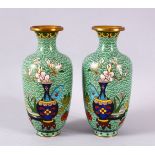 A PAIR OF CHINESE CLOISONNE APPLE GREEN GROUND VASES - each with a green ground with native
