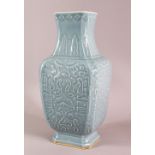 A CHINESE SKY BLUE GLAZED MOULDED PORCELAIN VASE, decorated with moulded panel decoration in archaic