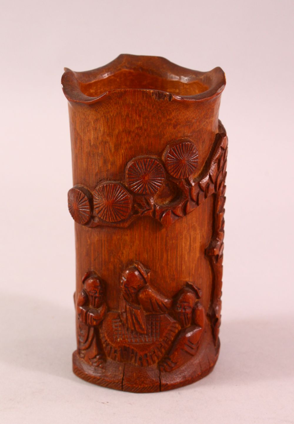 A CHINESE CARVED BAMBOO BRUSH WASH, carved with immortal and pine, 15cm.