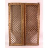 A PAIR OF INDIAN CARVED ROSEWOOD WINDOW SHUTTERS, with carved openwork panels, each section,