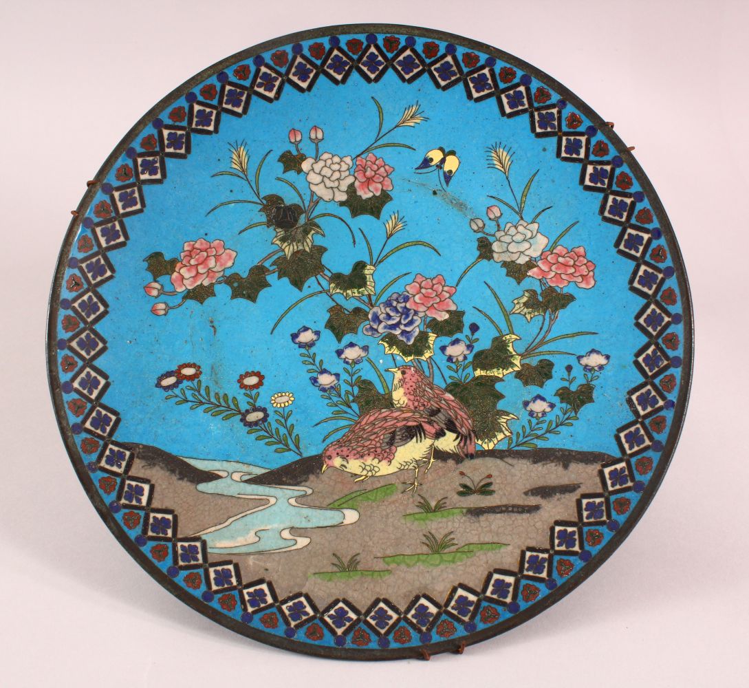 A JAPANESE CLOISONNE CIRCULAR DISH, decorated with quails by a stream, 30cm diameter.