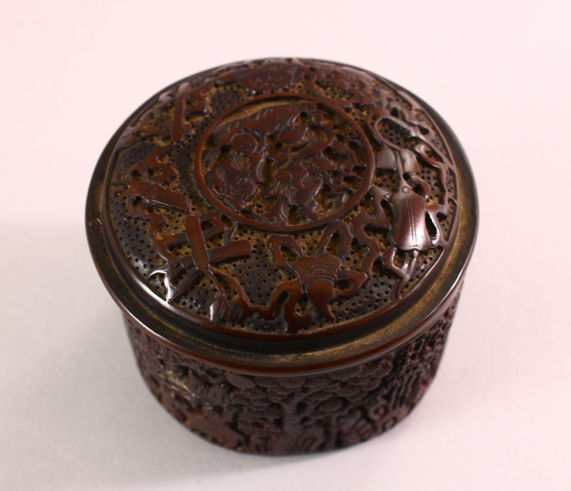 A CHINESE SMALL CIRCULAR CINNABAR LACQUER STYLE BOX AND COVER, decorated with figures in a