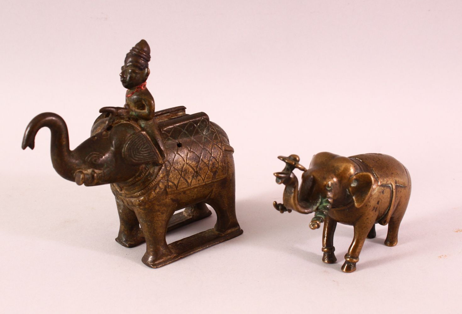 AN 18TH/19TH CENTURY INDIAN BRONZE ELEPHANT AND MAHOUT, together with another bronze elephant,