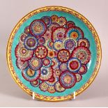 A CHINESE TURQUOISE GLAZED FAMILLE ROSE MILLEFLUER STYLE DISH, decorated with central flora upon