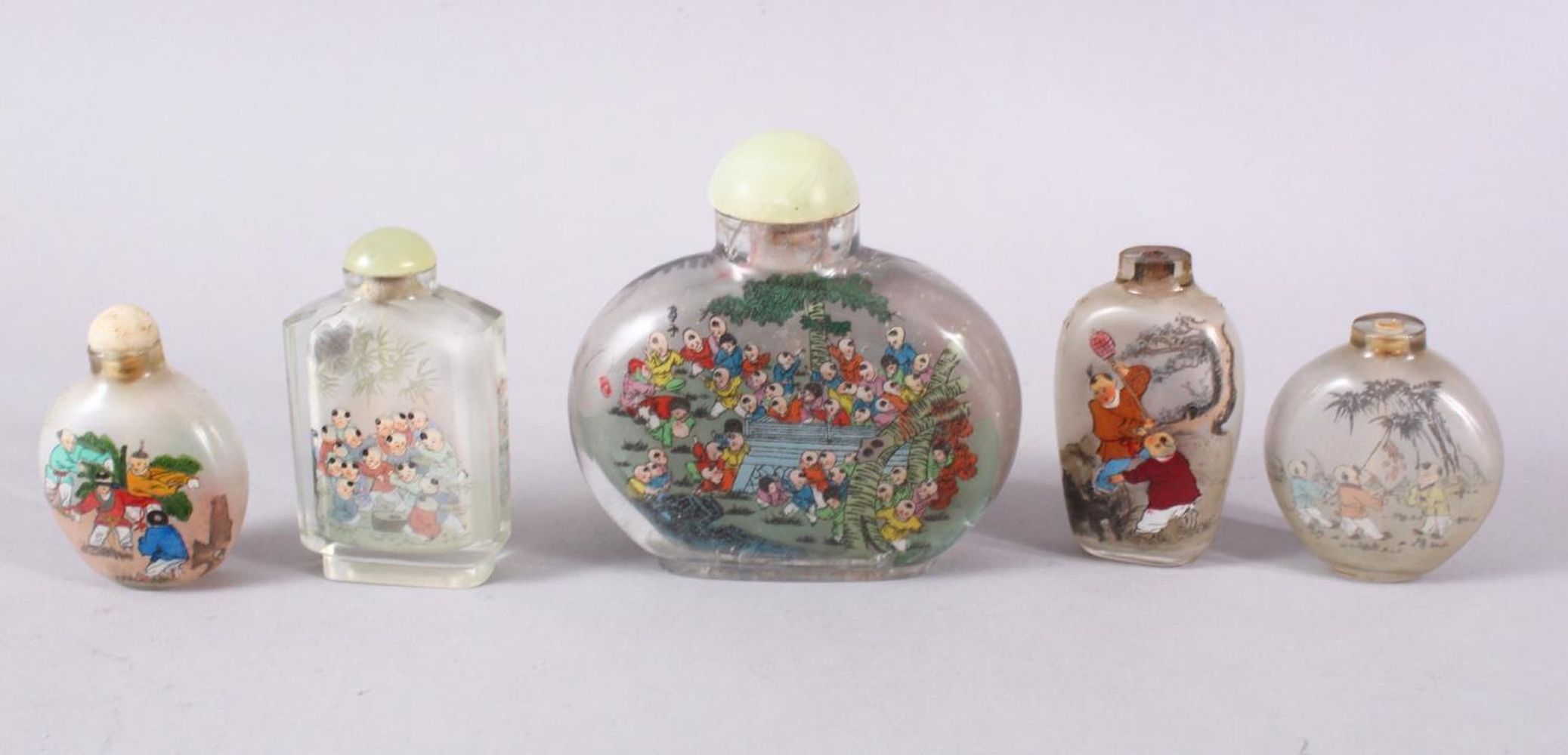 A MIXED LOT OF 5 CHINESE REVERSE PAINTED SNUFF BOTTLES, each with decoration of boys in