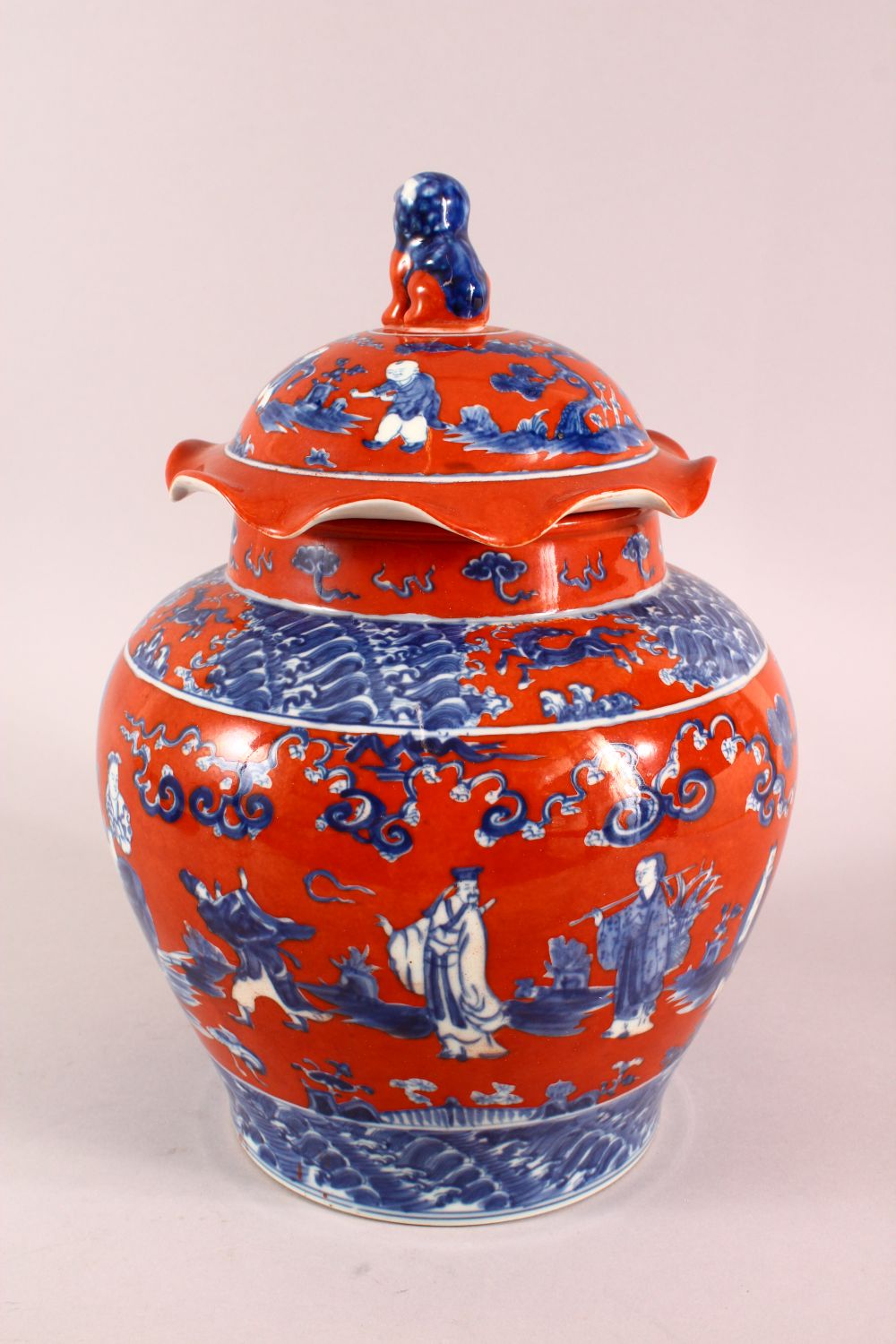 A CHINESE CORAL RED GROUND UNDERGLAZE BLUE PORCELAIN GINGER JAR & COVER, decorated with immortals in - Image 4 of 10