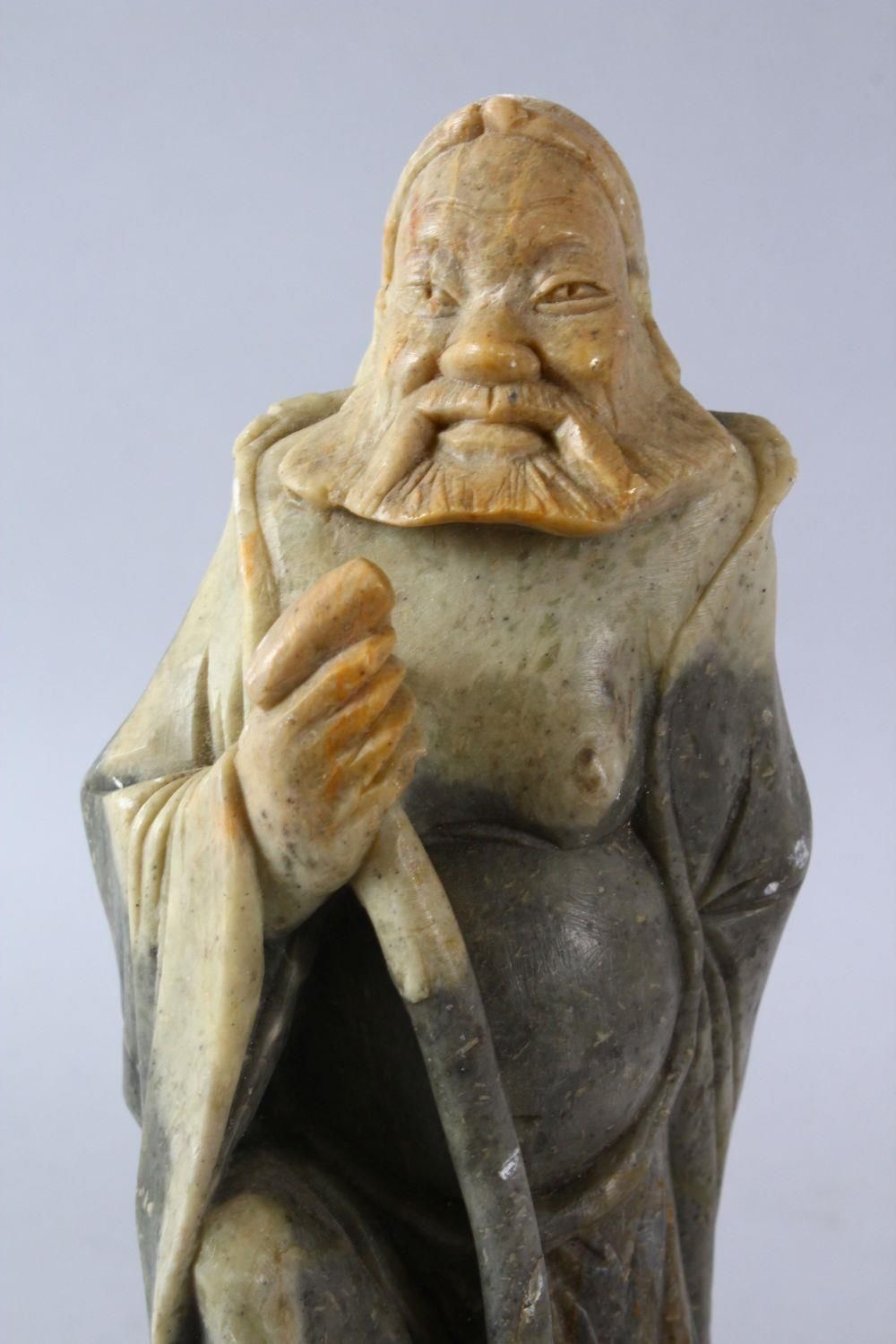 A LARGE CHINESE SOAPSTONE CARVING OF AN IMMORTAL, stood upon a rocky outcrop with a double groud, - Image 5 of 6