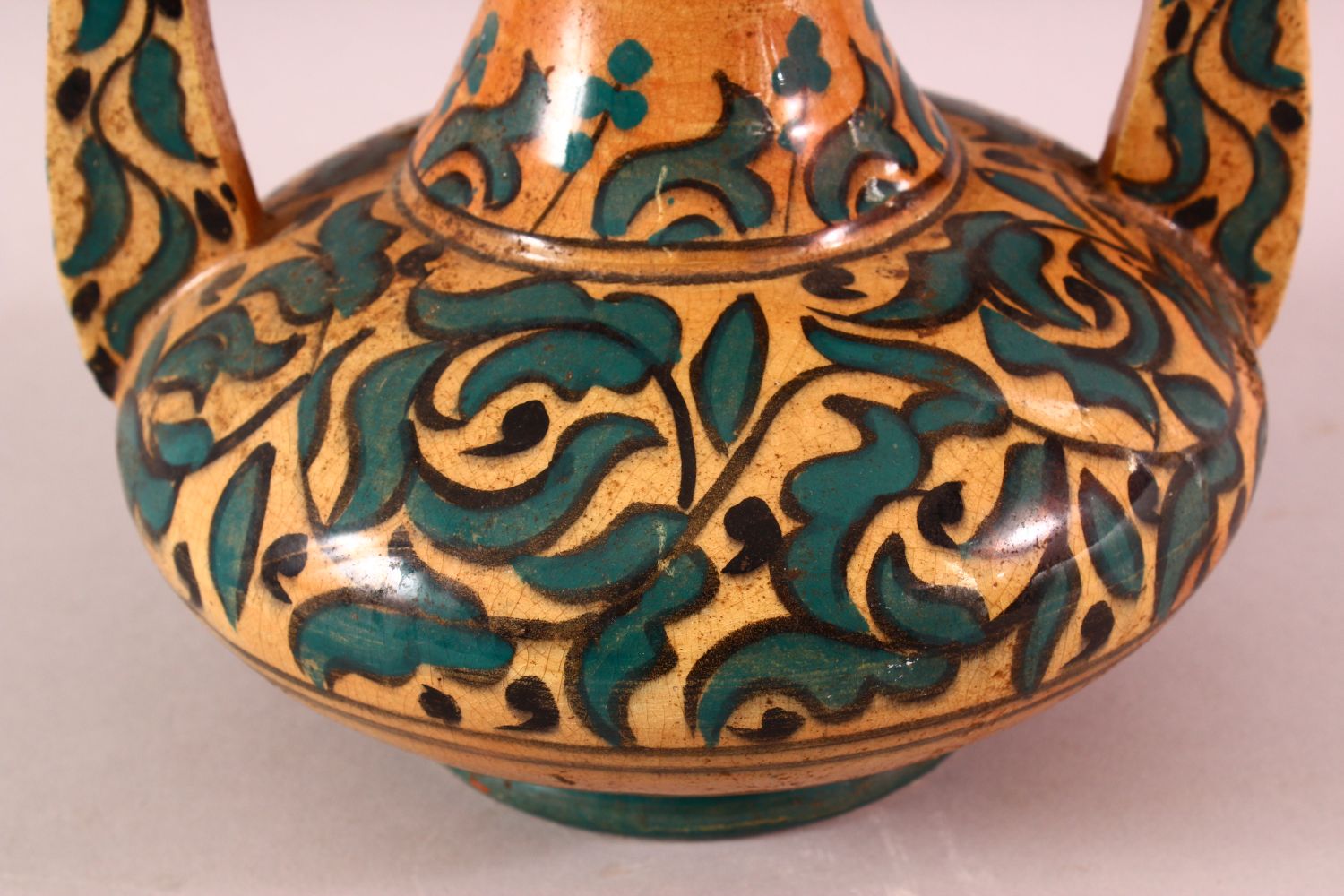 A MOROCCAN POTTERY FLORAL VASE - SIGNED BY BIN JALAL, with twin handles and green foliage - Image 3 of 8