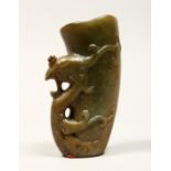 A CHINESE CARVED JADE LIBATION CUP, 5ins high.