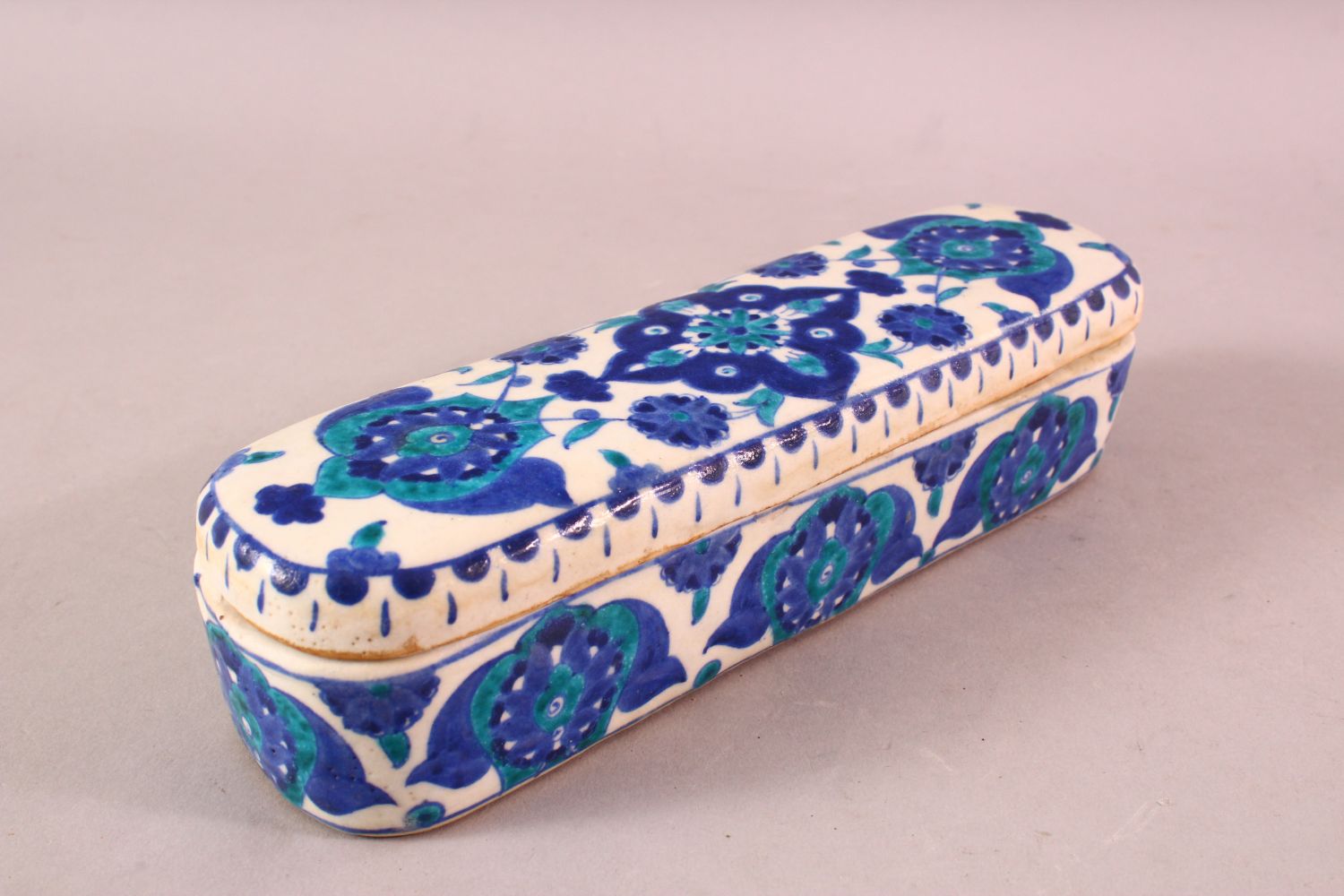 A TURKISH OTTOMAN KUTAHYA POTTERY PEN BOX & COVER, in blue and white floral decoration, 23cm - Image 2 of 4