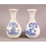 A PAIR OF JAPANESE HIRADO BLUE AND WHITE BOTTLE VASES, with moulded and painted decoration, 18cm