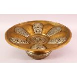 AN INDIAN SILVER INLAID BRASS BASIN, with pierced removable cover, 31cm diameter.