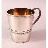 AN IRAQI SILVER AND NIELLO CUP, engraved with a band depicting a camel trek, 8cm high, weight 130g.