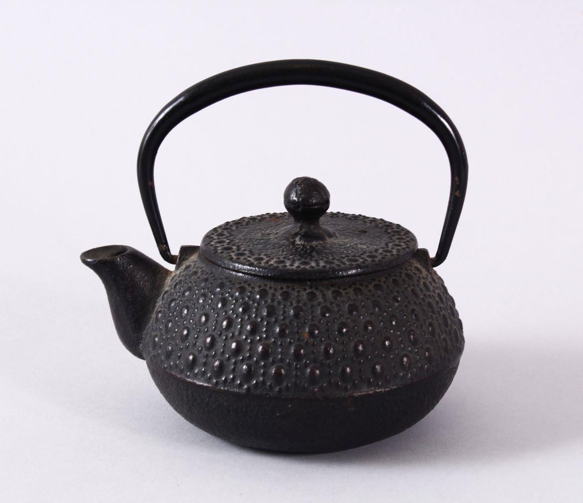 A JAPANESE IRON / METAL MOULDED TEAPOT & COVER, the body with moulded stud decoration, possibly iron