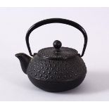 A JAPANESE IRON / METAL MOULDED TEAPOT & COVER, the body with moulded stud decoration, possibly iron