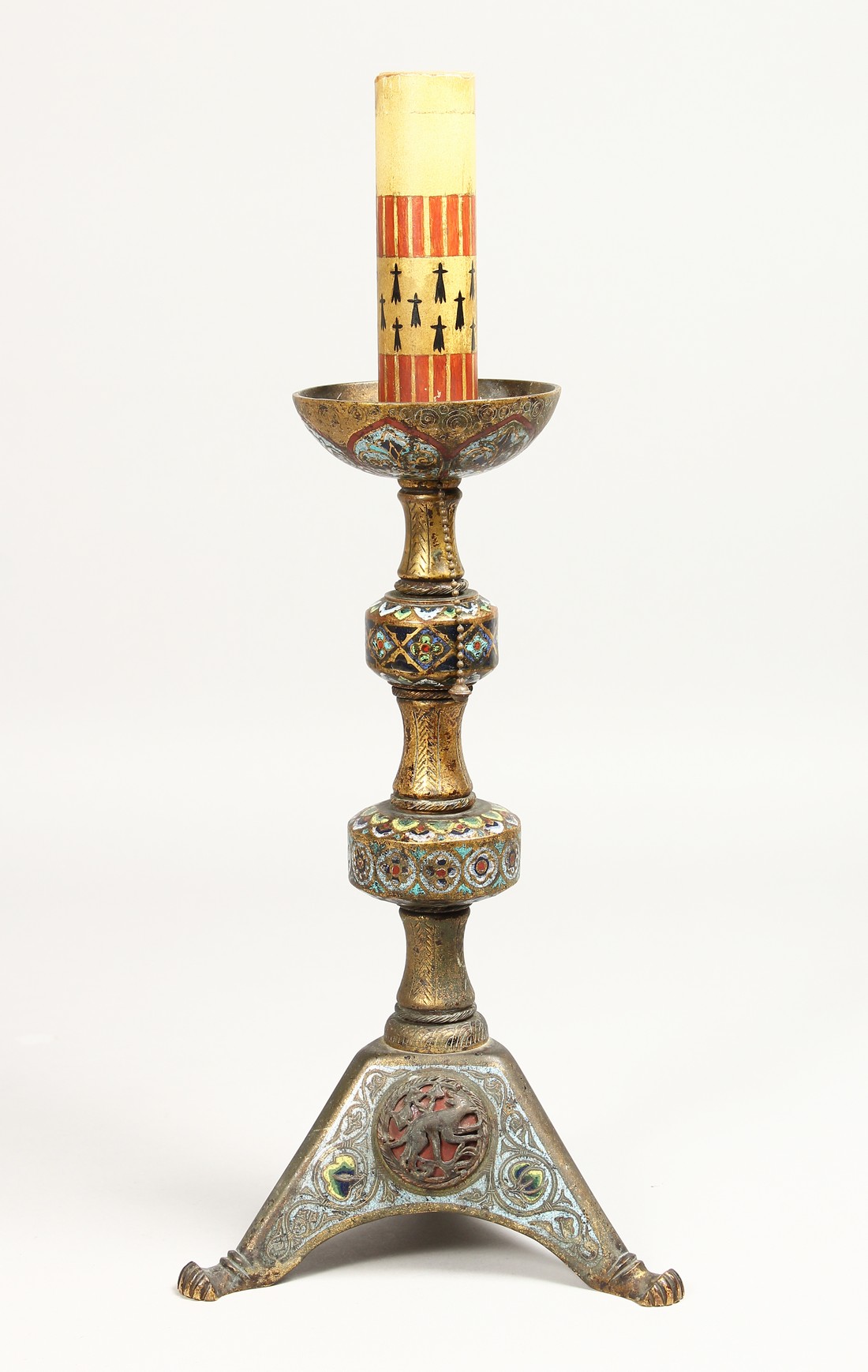 AN EARLY ORIENTAL CHAMPLEVE ENAMEL CANDLESTICK, 12ins high.