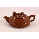 A CHINESE YIXING CLAY TEAPOT, with moulded beast like figures, the underside of the pot and lid with