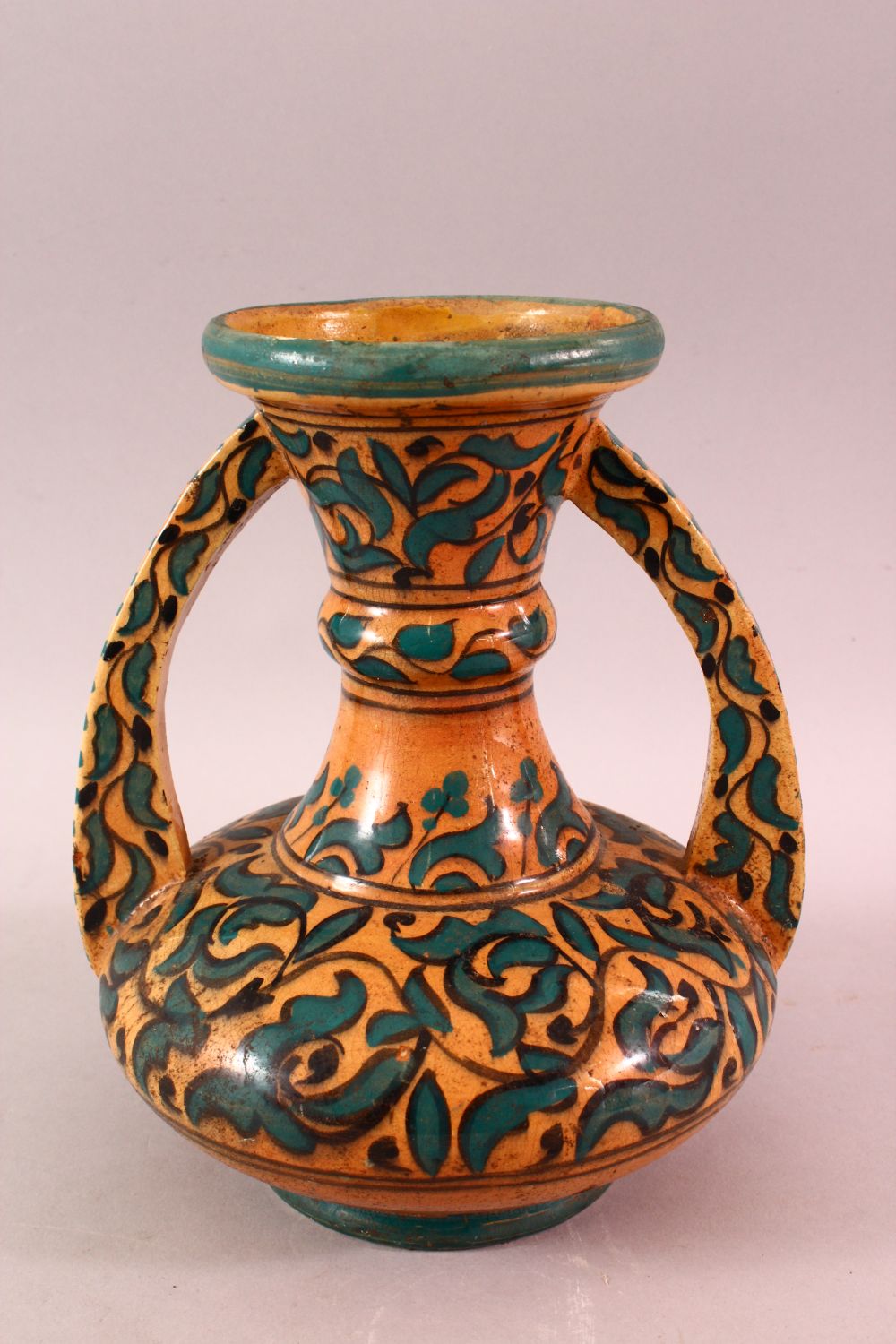 A MOROCCAN POTTERY FLORAL VASE - SIGNED BY BIN JALAL, with twin handles and green foliage - Image 5 of 8