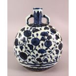 A CHINESE BLUE & WHITE PORCELAIN MOON FLASK, decorated with lotus and a six character mark, 27cm