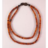 A RHINO HORN BEAD NECKLACE, beads approx. 10mm, weight 100g.