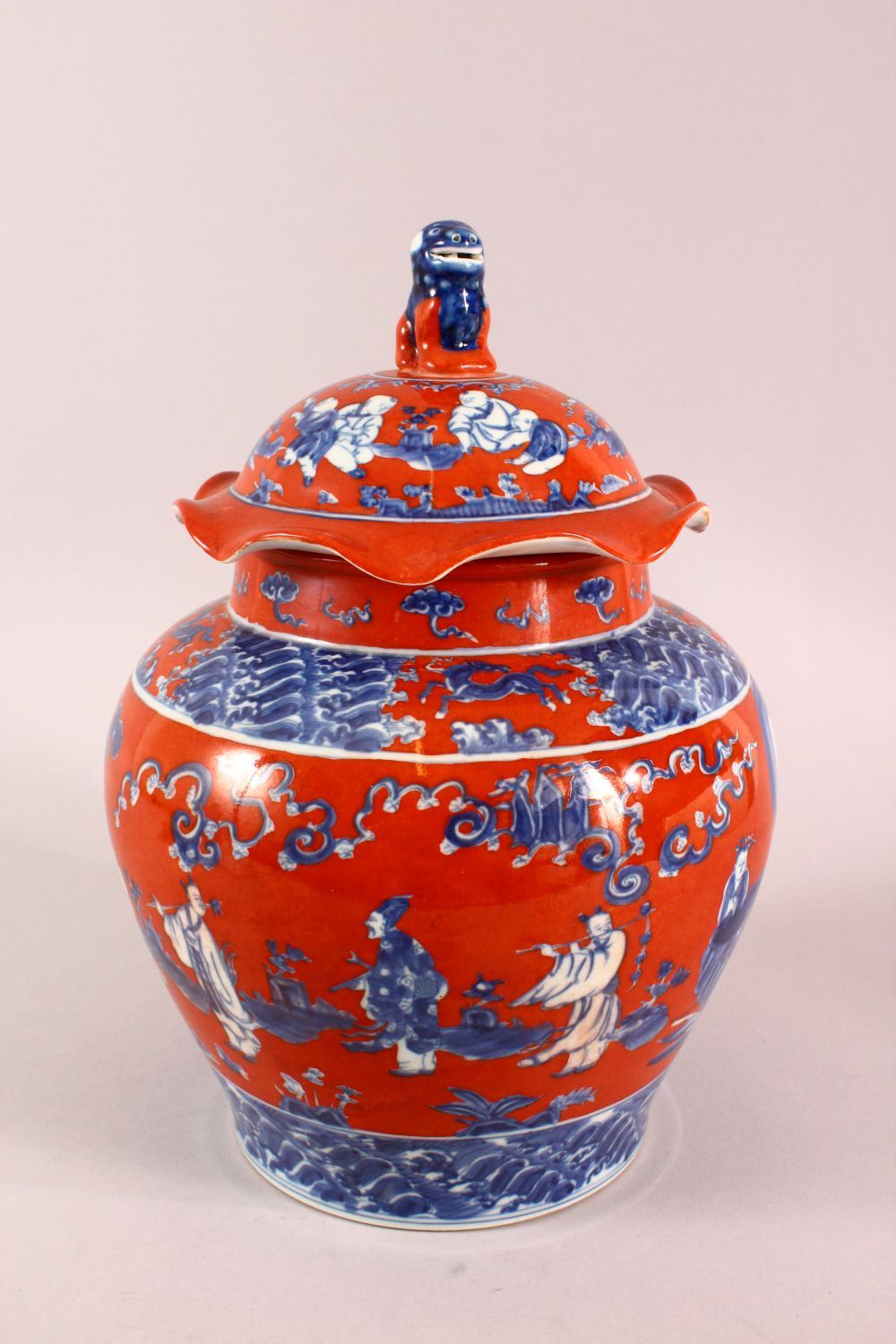 A CHINESE CORAL RED GROUND UNDERGLAZE BLUE PORCELAIN GINGER JAR & COVER, decorated with immortals in - Image 2 of 10