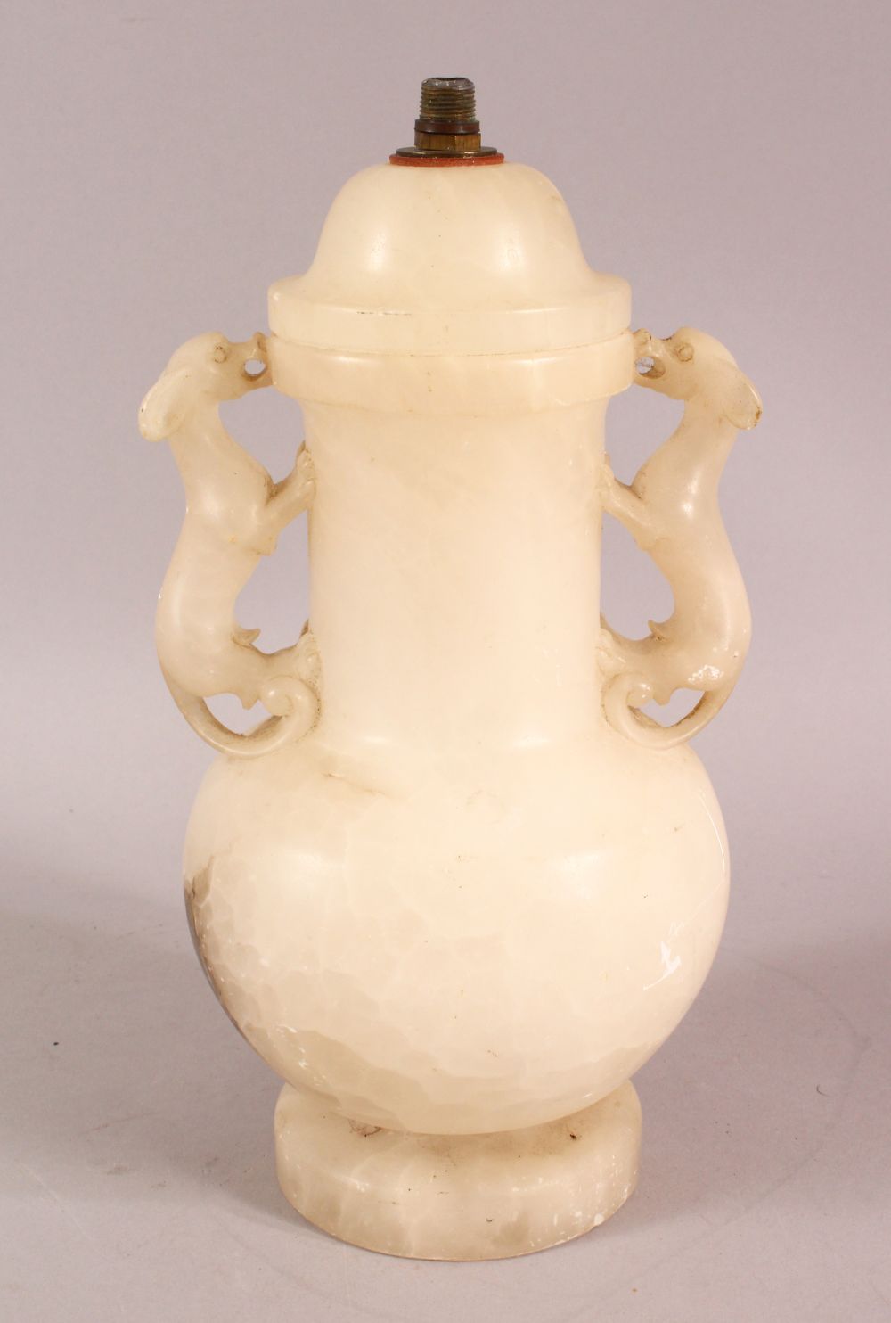 A CHINESE STYLE WHITE ONYX CARVED LIDDED VASE / LAMP, with twin moulded beast handles, overall 26.